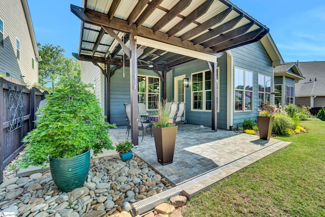 view of patio / terrace featuring a ceiling fan and fence