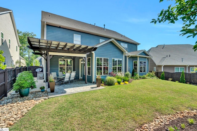 back of house with a yard, a pergola, a patio, and a fenced backyard