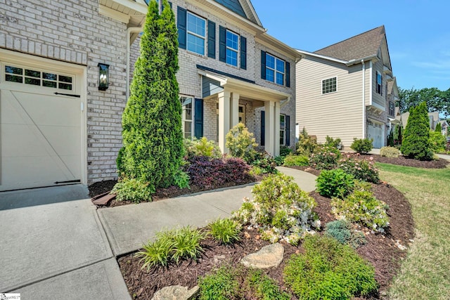 view of front of property with brick siding and driveway