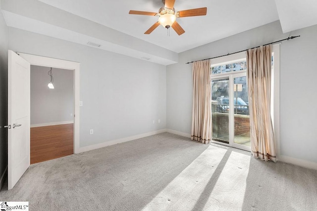 carpeted spare room with baseboards and ceiling fan