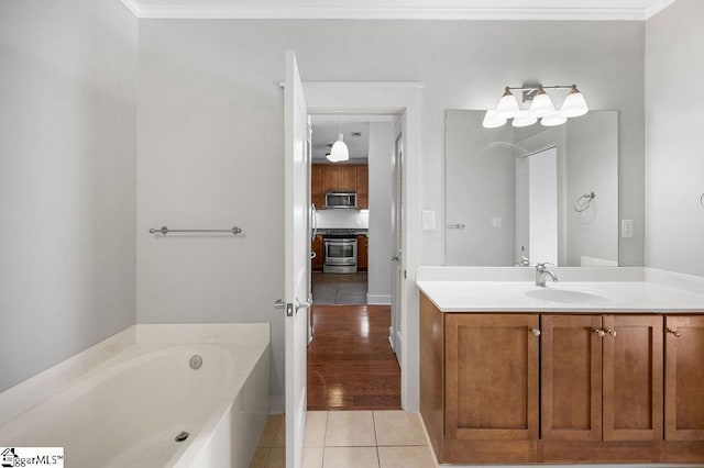 full bathroom with tile patterned floors, ornamental molding, vanity, and a garden tub