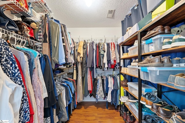 walk in closet featuring wood finished floors and visible vents