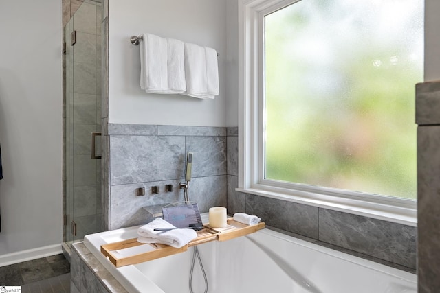 full bathroom featuring a garden tub and a stall shower