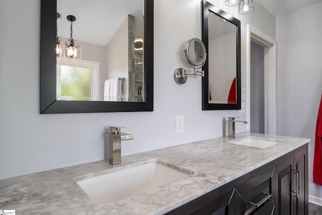 full bathroom with double vanity and a sink