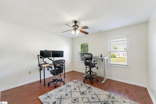 home office featuring a ceiling fan, wood finished floors, and visible vents
