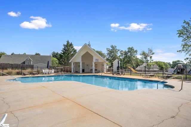 pool with fence and a patio