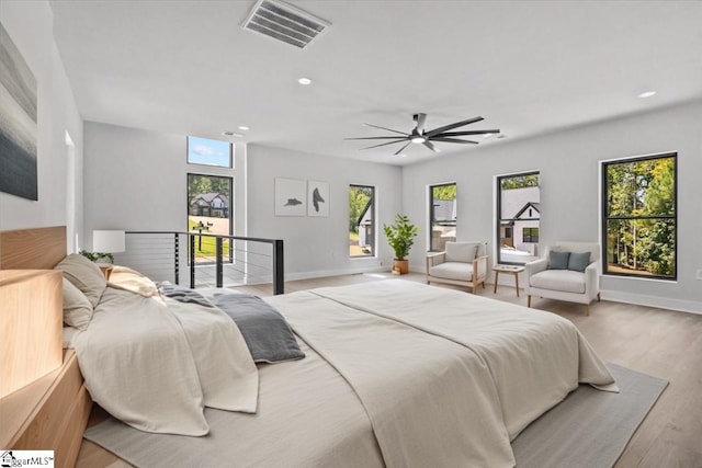 bedroom with ceiling fan, visible vents, wood finished floors, baseboards, and recessed lighting