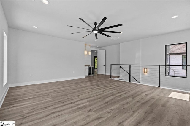 spare room with recessed lighting, a ceiling fan, and wood finished floors