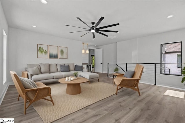 living room featuring recessed lighting, baseboards, ceiling fan, and wood finished floors