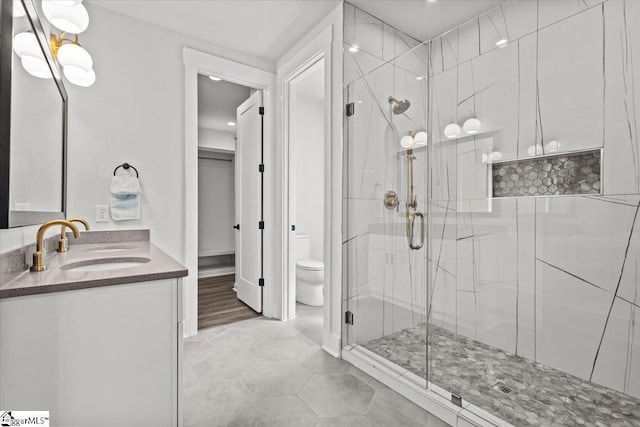 full bathroom with vanity, tile patterned floors, a stall shower, and toilet