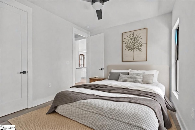bedroom featuring baseboards, a ceiling fan, and wood finished floors
