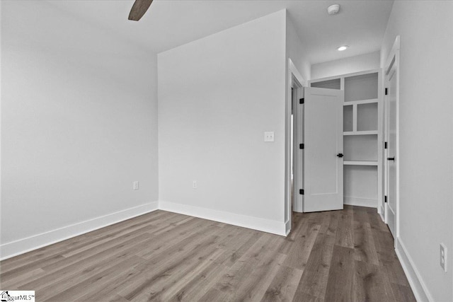 unfurnished bedroom featuring recessed lighting, baseboards, ceiling fan, and wood finished floors