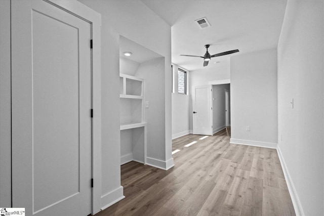 unfurnished bedroom with visible vents, baseboards, ceiling fan, and wood finished floors