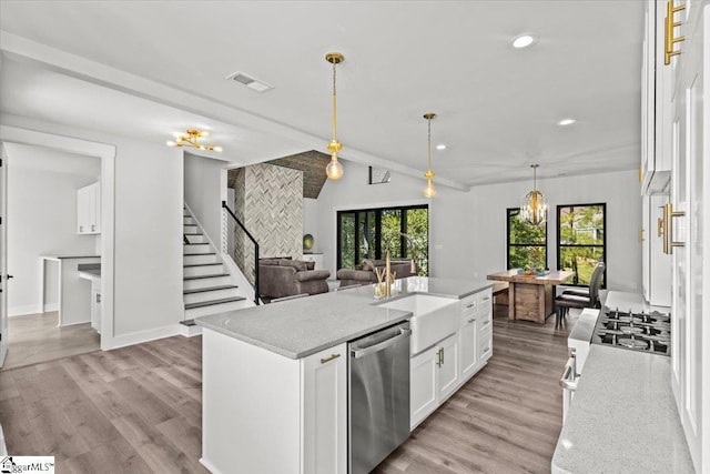 kitchen featuring visible vents, white cabinetry, dishwasher, and light wood-type flooring