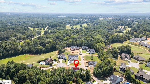 drone / aerial view featuring a forest view and a residential view