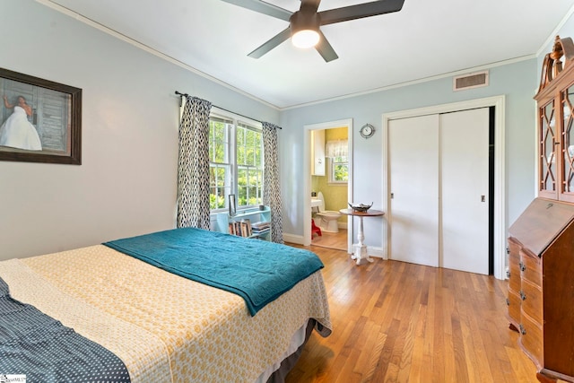 bedroom with a ceiling fan, visible vents, a closet, light wood-style floors, and ornamental molding