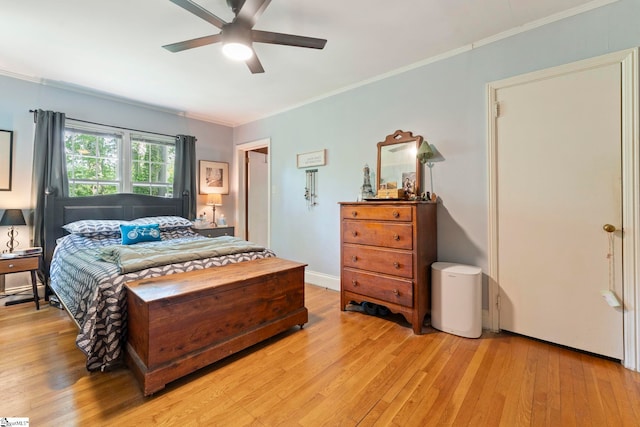bedroom with crown molding and light wood-style flooring