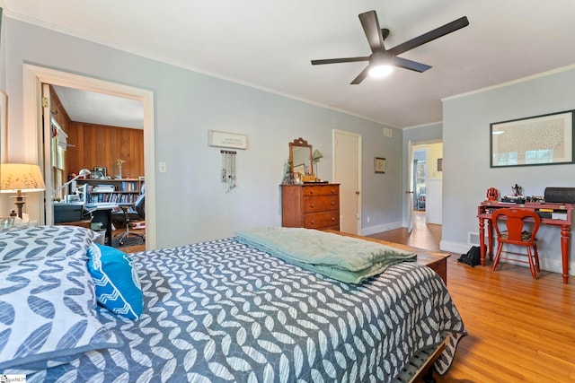 bedroom featuring ornamental molding, a ceiling fan, and wood finished floors