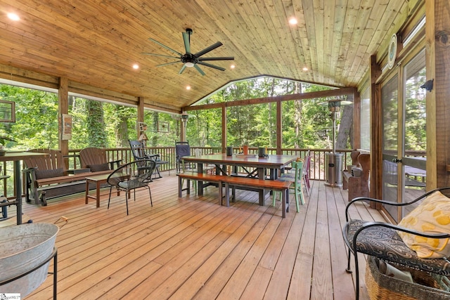 sunroom / solarium with outdoor dining area and a ceiling fan