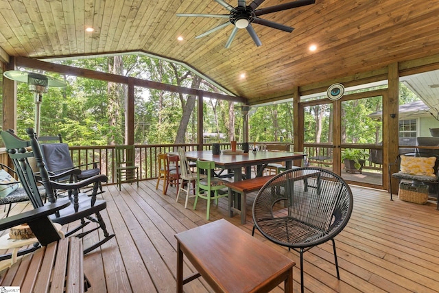 sunroom with a ceiling fan, outdoor dining area, and a healthy amount of sunlight