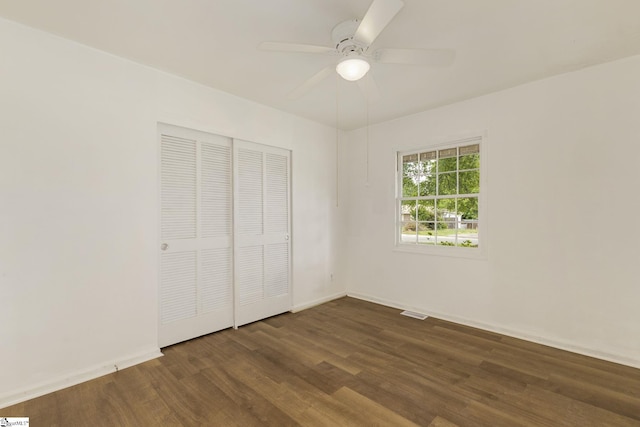 unfurnished bedroom with ceiling fan, baseboards, wood finished floors, visible vents, and a closet