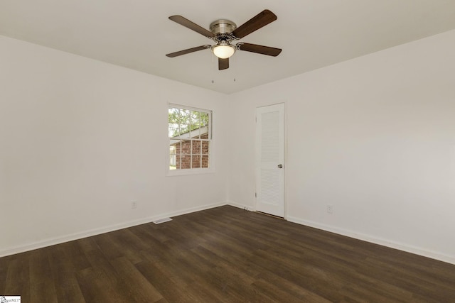 unfurnished room featuring dark wood-type flooring, baseboards, ceiling fan, and visible vents
