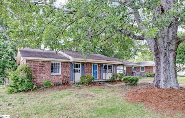 ranch-style house with brick siding and a front lawn