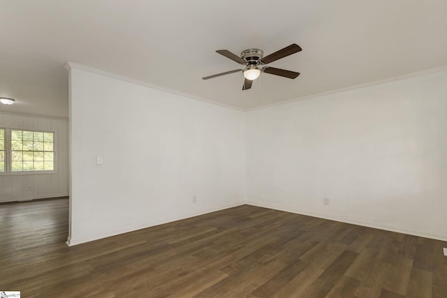 spare room with ceiling fan, ornamental molding, and dark wood-type flooring