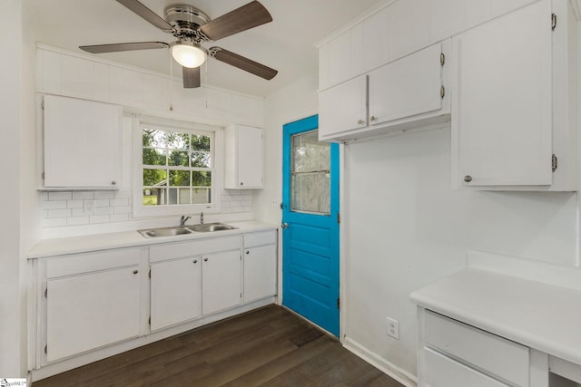 kitchen featuring light countertops, dark wood finished floors, and a sink
