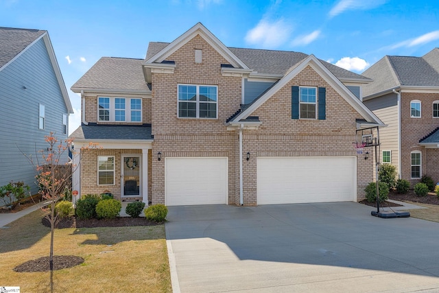 traditional home featuring driveway, brick siding, a front lawn, an attached garage, and a shingled roof