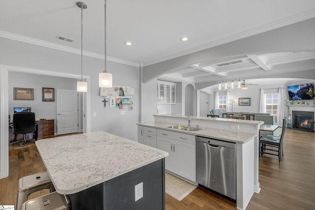 kitchen with a sink, a kitchen island with sink, dishwasher, and open floor plan