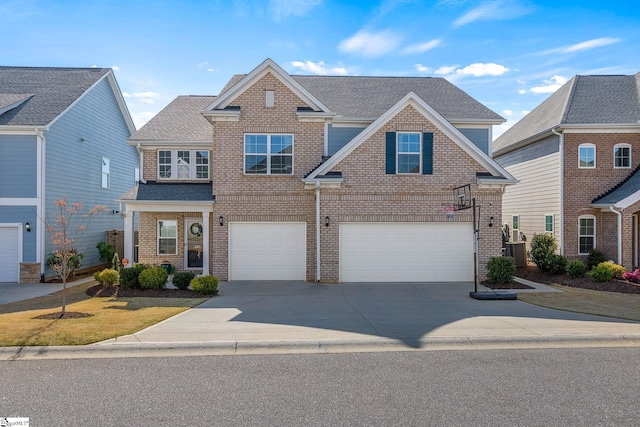 traditional-style home featuring roof with shingles, central AC unit, a garage, brick siding, and concrete driveway