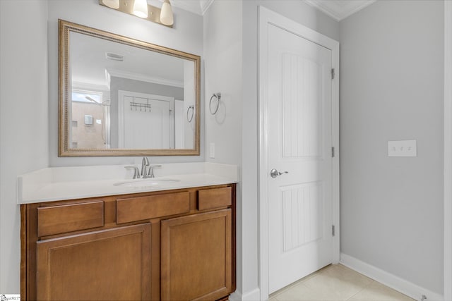 bathroom featuring vanity, ornamental molding, baseboards, and tile patterned floors