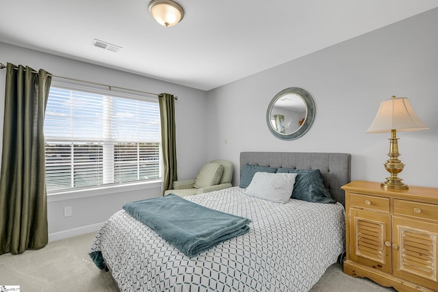bedroom featuring light colored carpet, baseboards, and visible vents