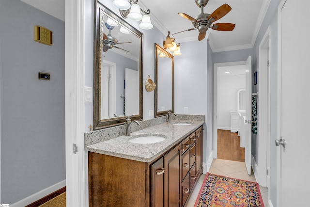 bathroom with ornamental molding, ceiling fan, a sink, and double vanity