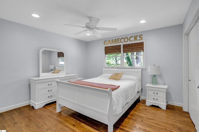 bedroom with multiple windows, light wood-style floors, and recessed lighting