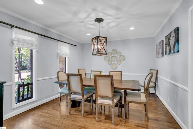 dining area with a notable chandelier, crown molding, recessed lighting, and wood finished floors