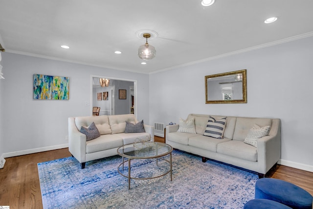 living room with wood finished floors, baseboards, and ornamental molding