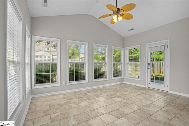 unfurnished sunroom with baseboards, high vaulted ceiling, visible vents, and stone tile flooring