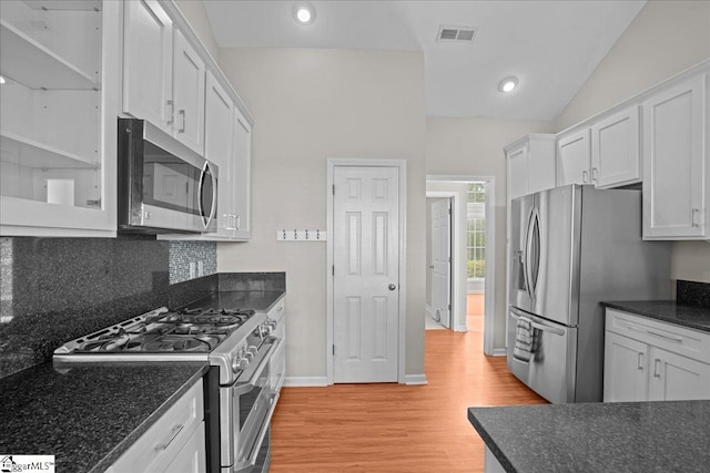 kitchen featuring stainless steel appliances, visible vents, light wood-style flooring, white cabinetry, and baseboards