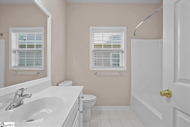 bathroom featuring toilet, baseboards, tile patterned flooring, vanity, and washtub / shower combination