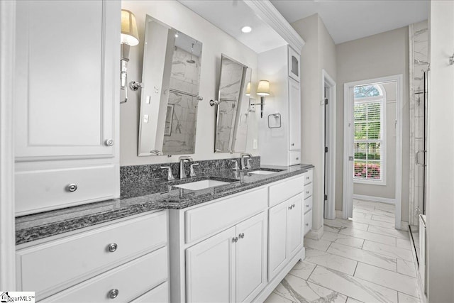 bathroom featuring a sink, double vanity, a marble finish shower, and marble finish floor