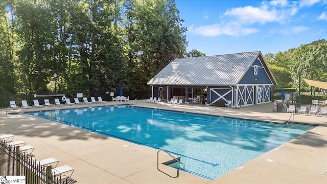 community pool featuring a patio and fence