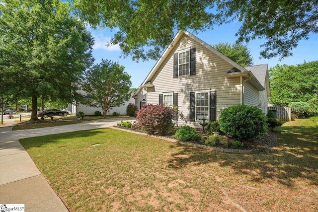 view of property exterior featuring a yard and driveway