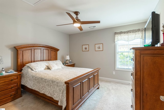 bedroom featuring light colored carpet, baseboards, a ceiling fan, and visible vents