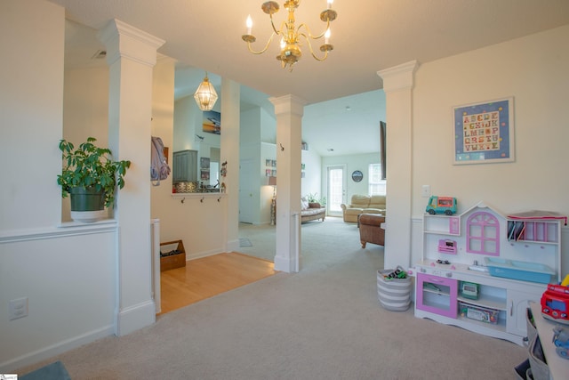 playroom featuring carpet, baseboards, an inviting chandelier, and decorative columns
