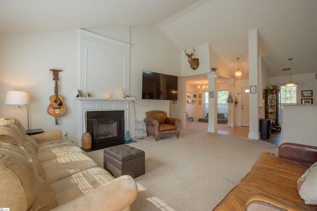 living room with carpet flooring, visible vents, decorative columns, high vaulted ceiling, and a fireplace