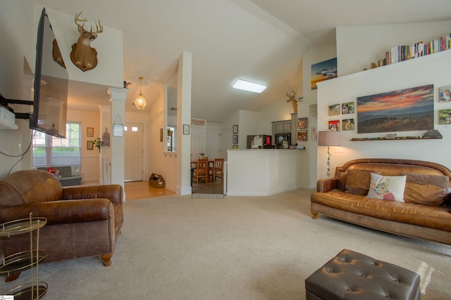 living area with carpet floors and high vaulted ceiling