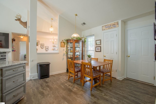 dining room with high vaulted ceiling, an inviting chandelier, visible vents, and dark wood-type flooring