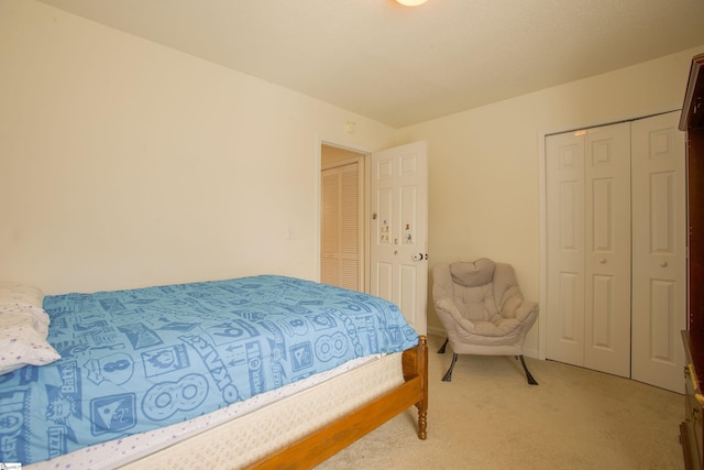 bedroom with a closet and light colored carpet